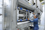 HELIAC's first cryomodule, the CM1: The superconducting solenoids and cavities are visible through the rectangular doors.